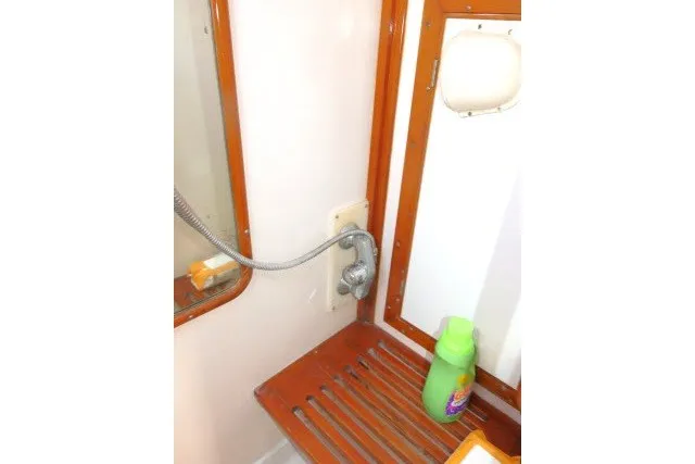 Slide: The Image of Interior of 1986 Tayana 52 Center Cockpit yacht bathroom with shower and wooden shelf. - 48