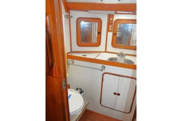 Slide: The Image of Bathroom interior of 1986 Tayana 52 Center Cockpit yacht with wooden accents. - 31