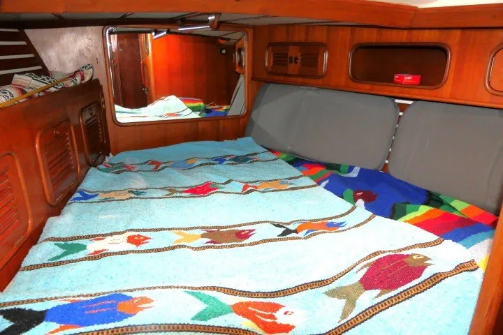 Slide: The Image of Cozy cabin interior of 1986 Tayana 52 Center Cockpit with colorful bedding and wooden accents. - 25