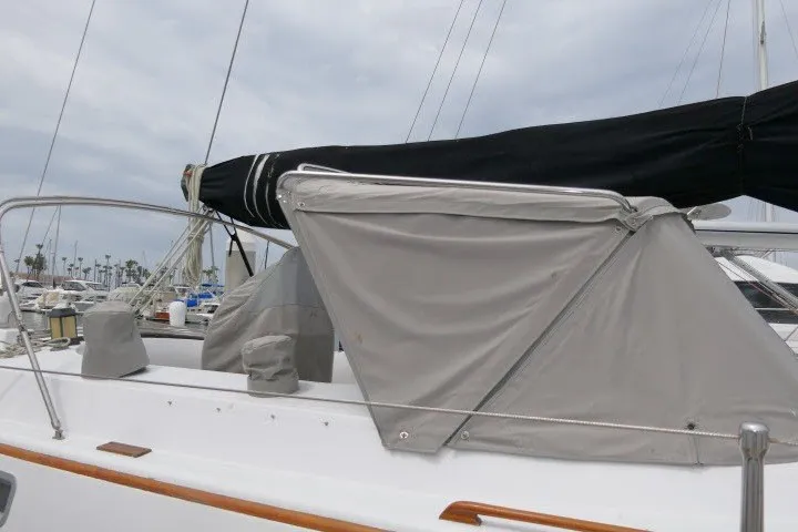 Slide: The Image of 1986 Tayana 52 Center Cockpit sailboat with covered deck and rigging in marina. - 67
