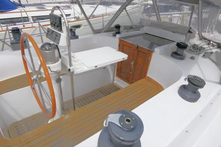 Slide: The Image of 1986 Tayana 52 Center Cockpit sailboat interior with steering wheel and navigation controls. - 54