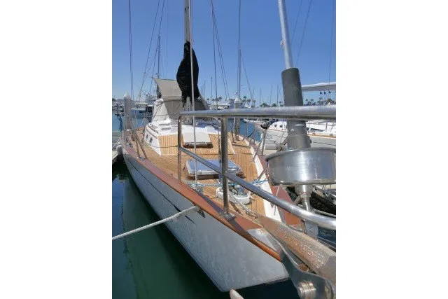 Slide: The Image of 1986 Tayana 52 Center Cockpit sailboat docked in a marina under clear blue skies. - 68