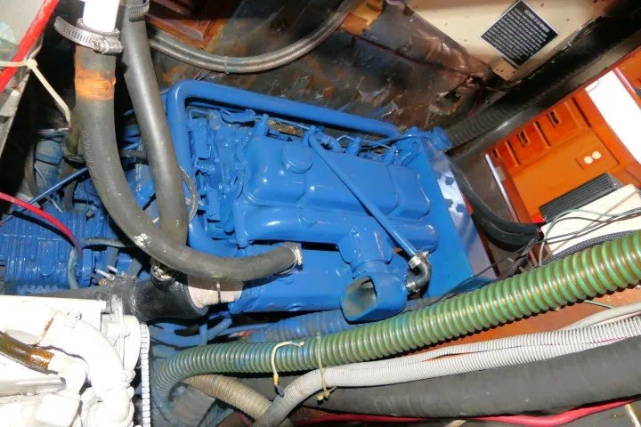 Slide: The Image of Engine compartment of a 1986 Tayana 52 Center Cockpit sailboat, featuring a blue engine. - 81