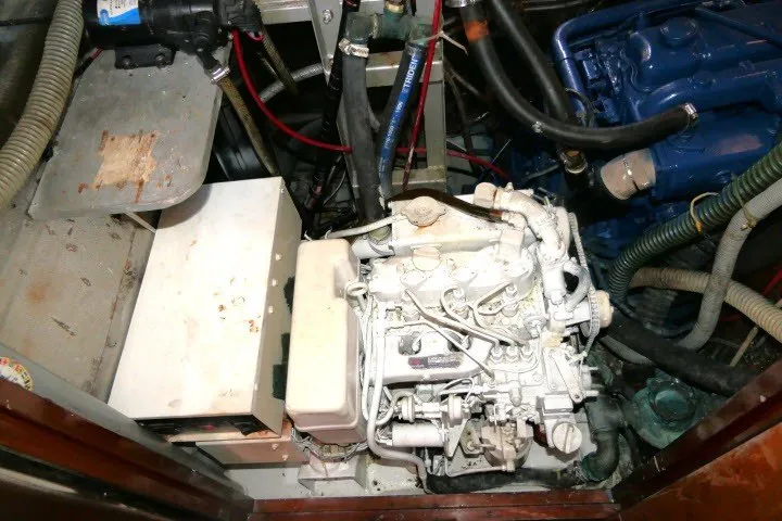 Slide: The Image of Engine compartment of a 1986 Tayana 52 Center Cockpit sailboat, showcasing mechanical components. - 84
