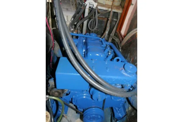 Slide: The Image of Blue engine of a 1986 Tayana 52 Center Cockpit sailboat, showcasing mechanical components. - 82
