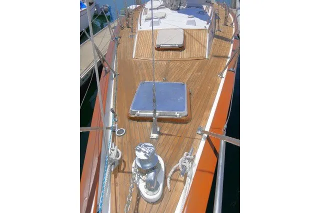 Slide: The Image of 1986 Tayana 52 Center Cockpit sailboat deck with wooden finish and hatch. - 66
