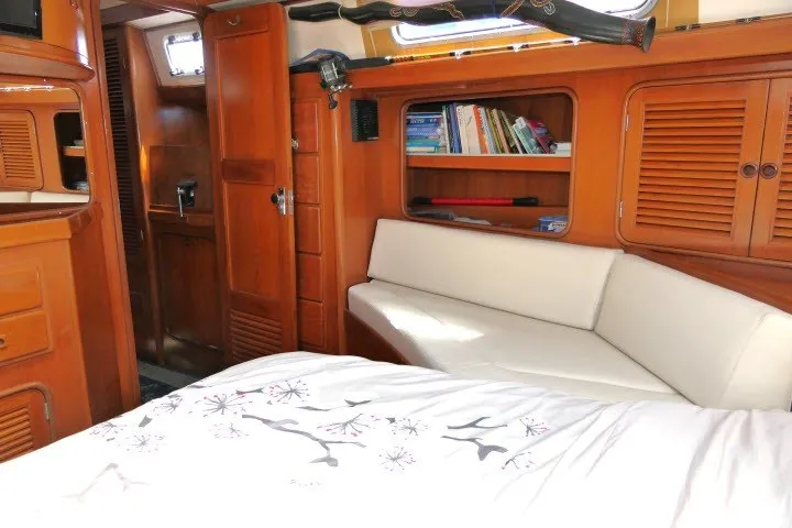 Slide: The Image of Interior of 1986 Tayana 52 Center Cockpit yacht with wood finish and cozy seating. - 42