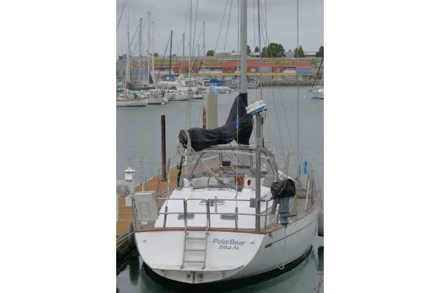 Slide: The Image of 1986 Tayana 52 Center Cockpit sailboat docked in a marina. - 87