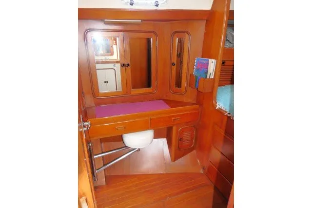 Slide: The Image of Interior of 1986 Tayana 52 Center Cockpit yacht with wooden cabinetry and mirror. - 22