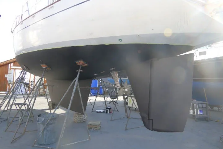 Slide: The Image of 1986 Tayana 52 Center Cockpit sailboat on stands, showcasing hull and keel maintenance. - 72