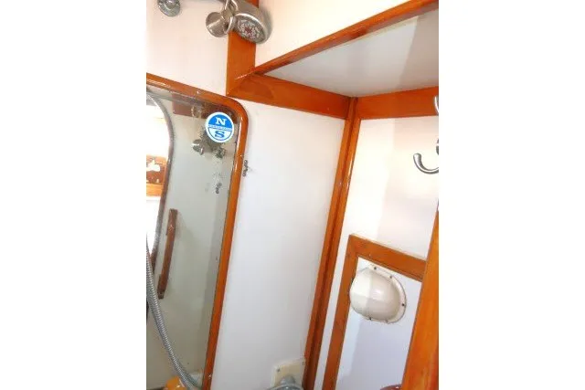 Slide: The Image of Interior of 1986 Tayana 52 Center Cockpit, featuring wooden trim and nautical decor. - 47