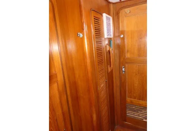 Slide: The Image of Wooden interior of 1986 Tayana 52 Center Cockpit yacht, featuring doors and paneling. - 28