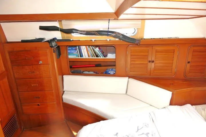 Slide: The Image of Cozy cabin interior of 1986 Tayana 52 Center Cockpit with wooden cabinetry and white seating. - 41