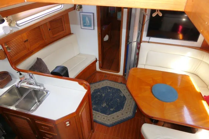 Slide: The Image of Interior of 1986 Tayana 52 Center Cockpit yacht with cozy seating and wooden finishes. - 3