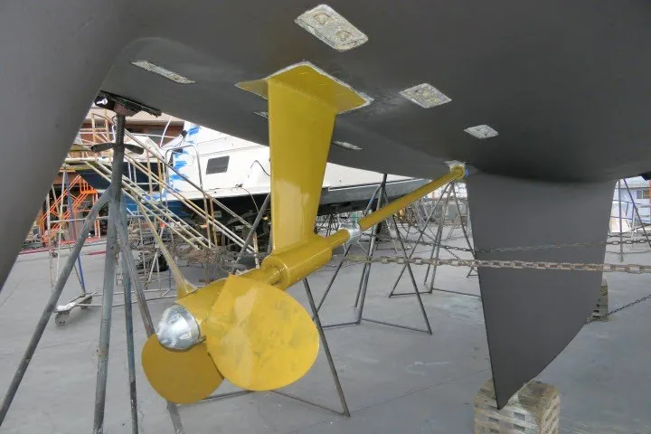 Slide: The Image of Yellow propeller and rudder of 1986 Tayana 52 Center Cockpit sailboat in dry dock. - 74