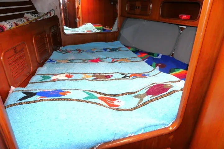 Slide: The Image of Cozy cabin interior of 1986 Tayana 52 Center Cockpit with colorful bedding. - 24