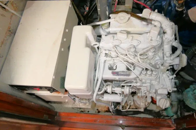 Slide: The Image of Engine compartment of a 1986 Tayana 52 Center Cockpit sailboat, showcasing mechanical components. - 85