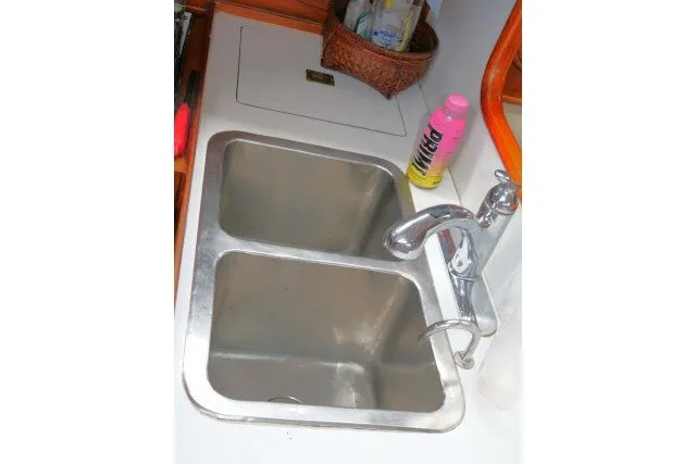 Slide: The Image of Stainless steel double sink in 1986 Tayana 52 Center Cockpit yacht kitchen. - 14