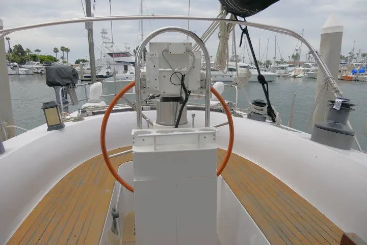 Slide: The Image of 1986 Tayana 52 Center Cockpit sailboat with wooden deck, docked in a marina. - 50
