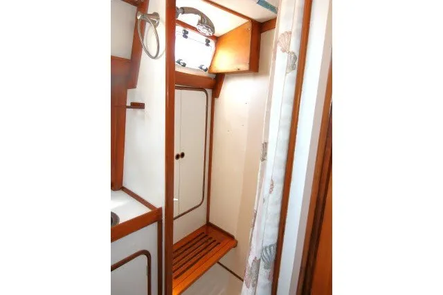 Slide: The Image of Interior of 1986 Tayana 52 Center Cockpit yacht, featuring wooden accents and compact design. - 32