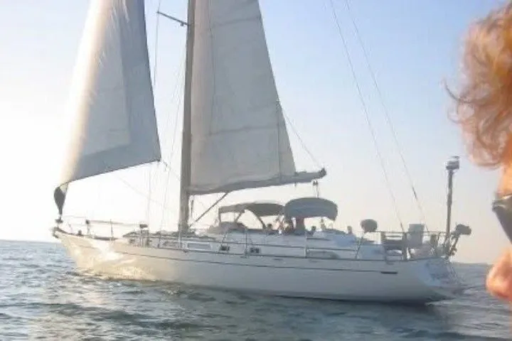 Slide: The Image of 1986 Tayana 52 Center Cockpit sailboat cruising on open water under clear skies. - 88