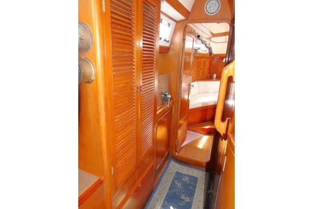 Slide: The Image of Interior of 1986 Tayana 52 Center Cockpit yacht with wooden cabinetry and cozy design. - 34