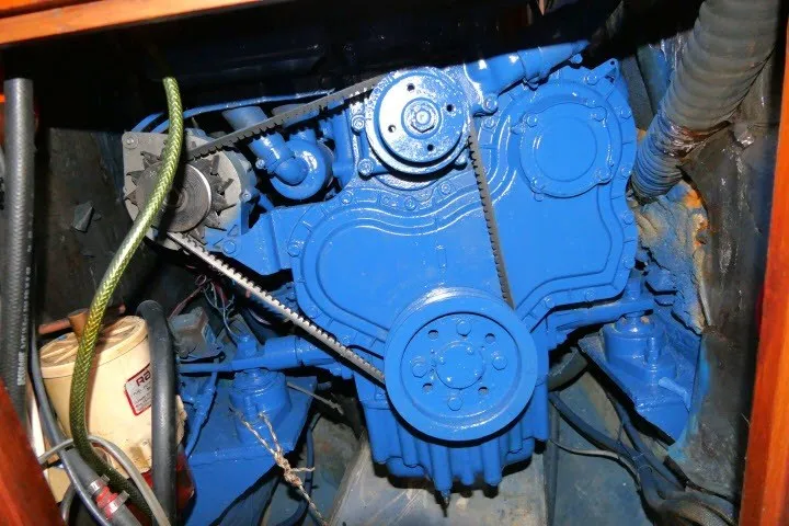 Slide: The Image of Engine compartment of a 1986 Tayana 52 Center Cockpit sailboat, featuring a blue-painted engine. - 83