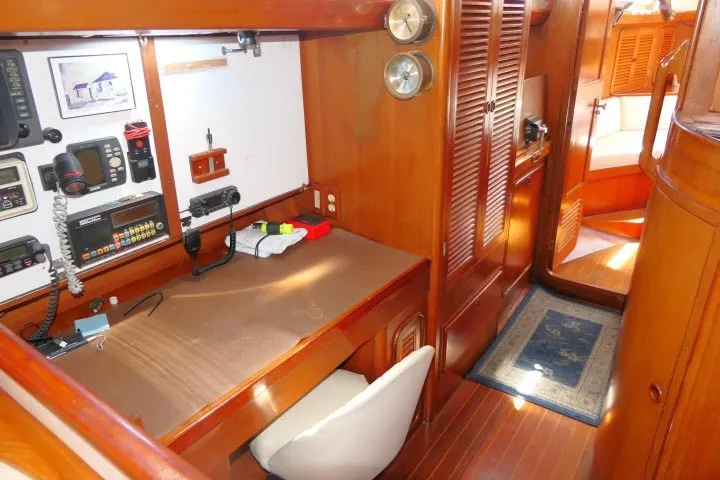 Slide: The Image of 1986 Tayana 52 Center Cockpit interior with navigation station and wooden cabinetry. - 33