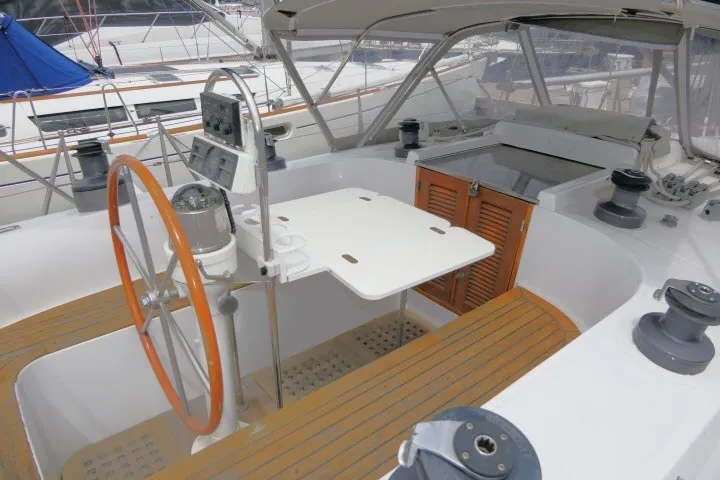Slide: The Image of 1986 Tayana 52 Center Cockpit sailboat with wooden accents and navigation equipment. - 56