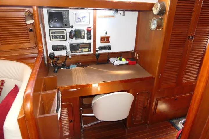 Slide: The Image of Navigation station in 1986 Tayana 52 Center Cockpit yacht with wooden cabinetry and instruments. - 16