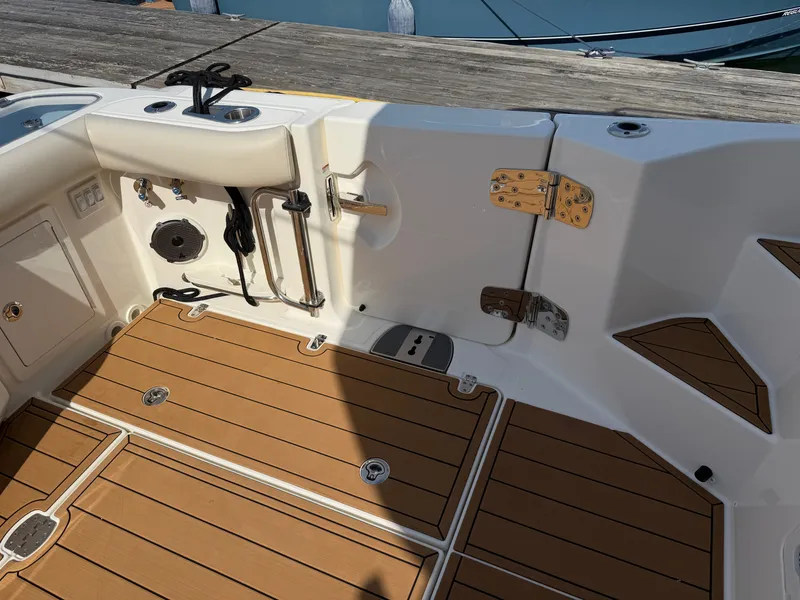 Slide: The Image of The image shows the cockpit of a 2024 Boston Whaler 405 Conquest with teak flooring and fishing gear. - 25
