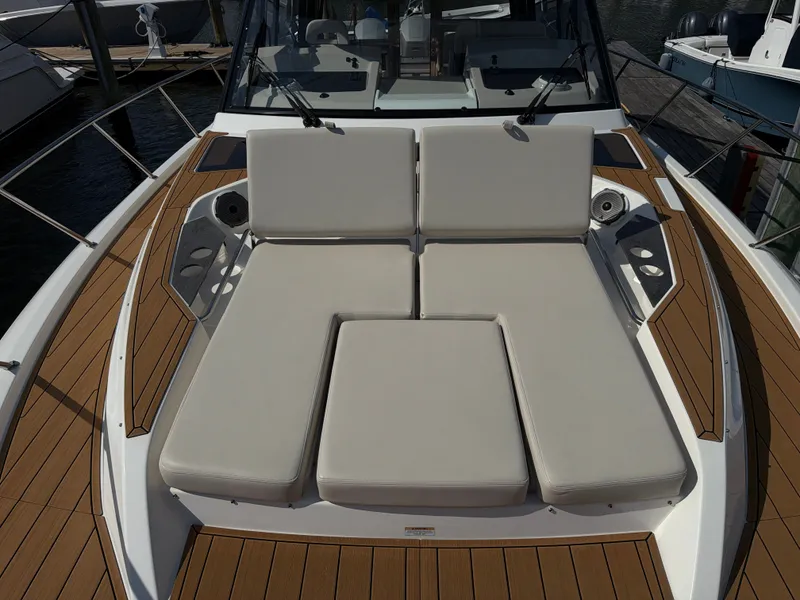 Slide: The Image of The 2024 Boston Whaler 405 Conquest features a sleek deck with comfortable cushions and wood accents. - 40