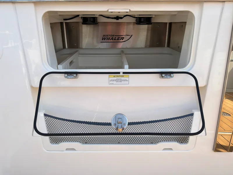 Slide: The Image of An open storage compartment on a 2024 Boston Whaler 405 Conquest boat. - 32