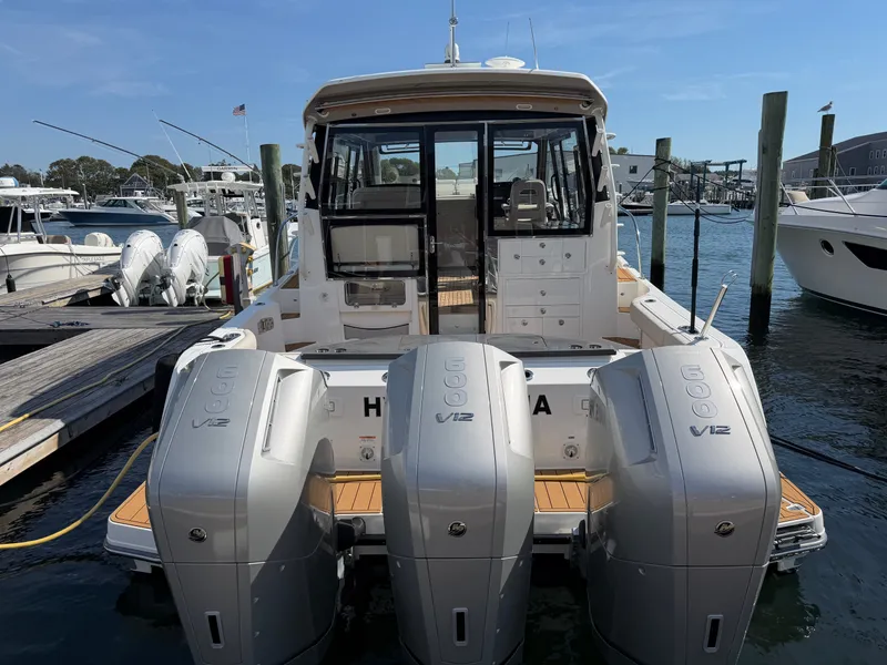 Slide: The Image of The image shows a 2024 Boston Whaler 405 Conquest boat with three V12 engines at the stern. - 16