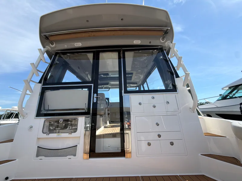 Slide: The Image of The 2024 Boston Whaler 405 Conquest features a modern cabin with glass sliding doors and storage. - 28