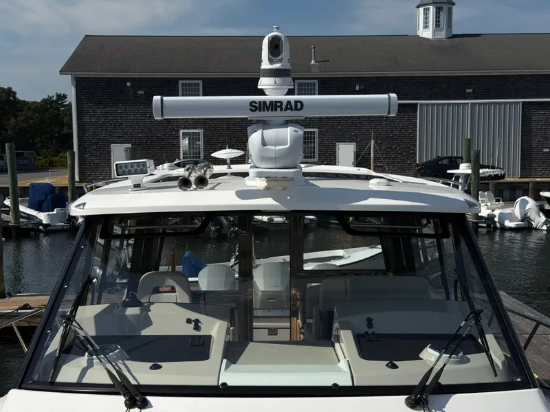 Slide: The Image of The 2024 Boston Whaler 405 Conquest is docked, featuring a modern navigation system. - 41