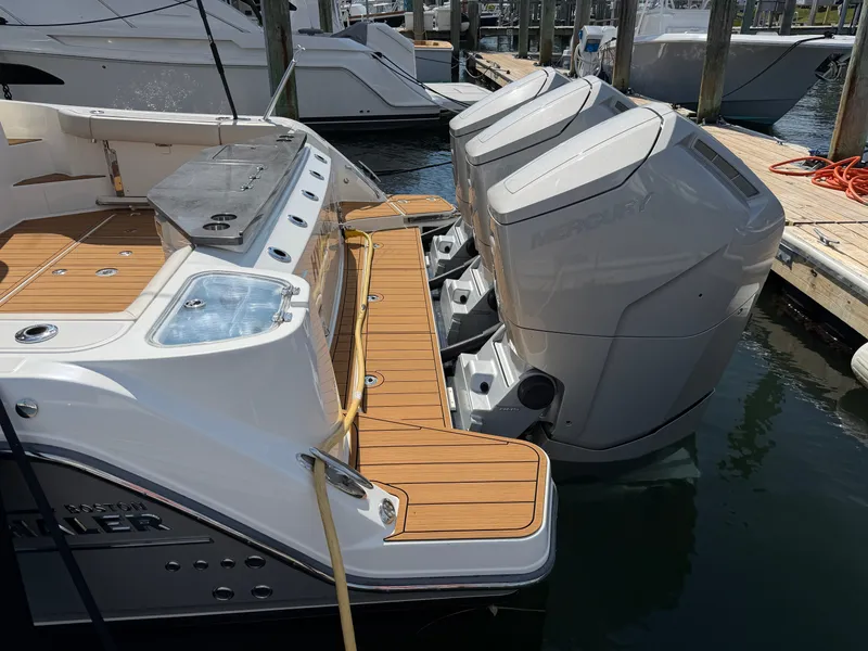 Slide: The Image of The image shows the stern of a Boston Whaler 405 Conquest with three Mercury outboard engines. - 17