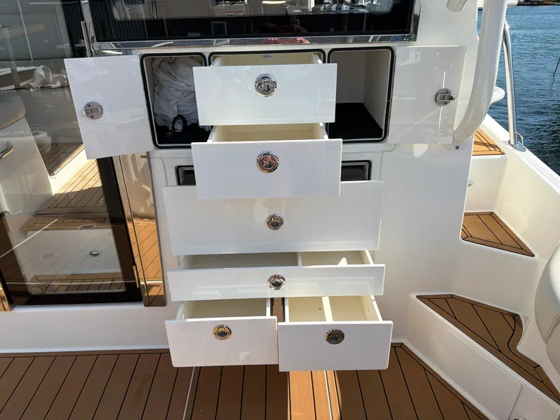 Slide: The Image of The 2024 Boston Whaler 405 Conquest features open drawers on a sleek deck. - 29