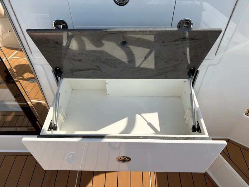 Slide: The Image of Open storage compartment with hydraulic arms on a boat. - 31