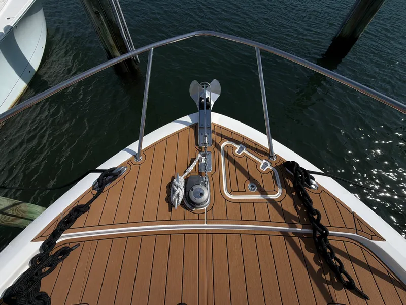 Slide: The Image of The bow of a 2024 Boston Whaler 405 Conquest with anchor and wooden deck. - 42