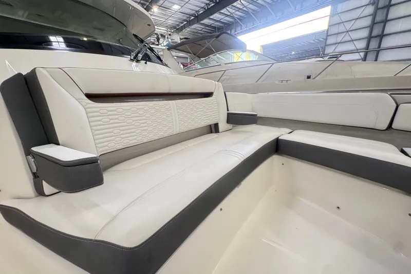Slide: The Image of Luxurious seating on a 2021 Tiara Sport 38 LS boat, featuring elegant white upholstery. - 12