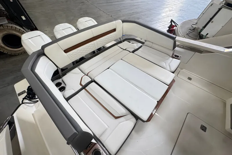 Slide: The Image of Luxurious seating area on a 2021 Tiara Sport 38 LS boat, featuring white cushioned seats. - 5