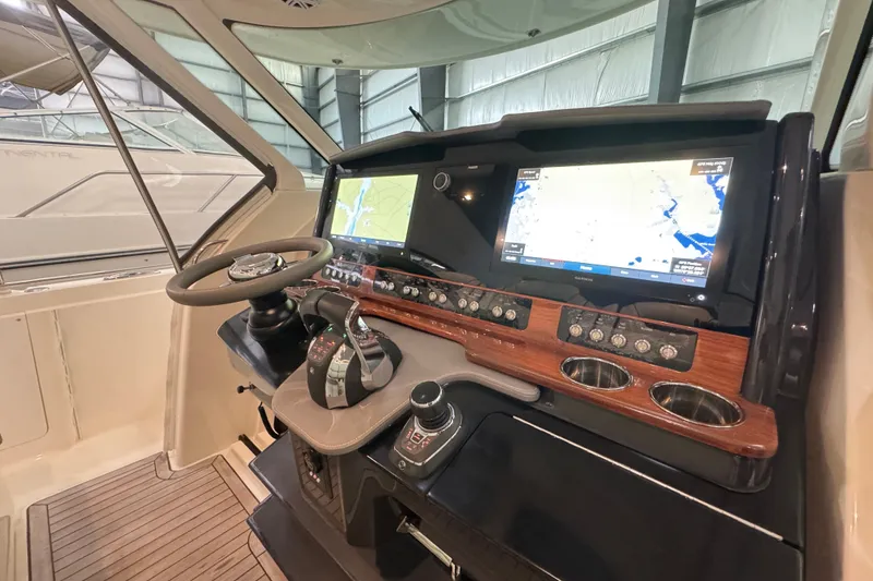 Slide: The Image of 2021 Tiara Sport 38 LS helm with dual navigation screens and modern controls. - 9