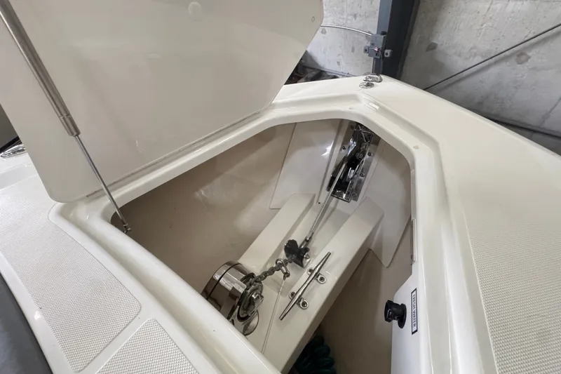 Slide: The Image of 2021 Tiara Sport 38 LS boat anchor compartment with open hatch and visible anchor chain. - 15