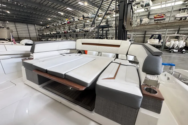 Slide: The Image of 2021 Tiara Sport 38 LS luxury boat interior with plush seating in a spacious marina. - 4