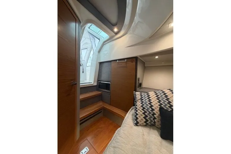 Slide: The Image of Interior of 2021 Tiara Sport 38 LS yacht, featuring modern wood finishes and cozy seating. - 28