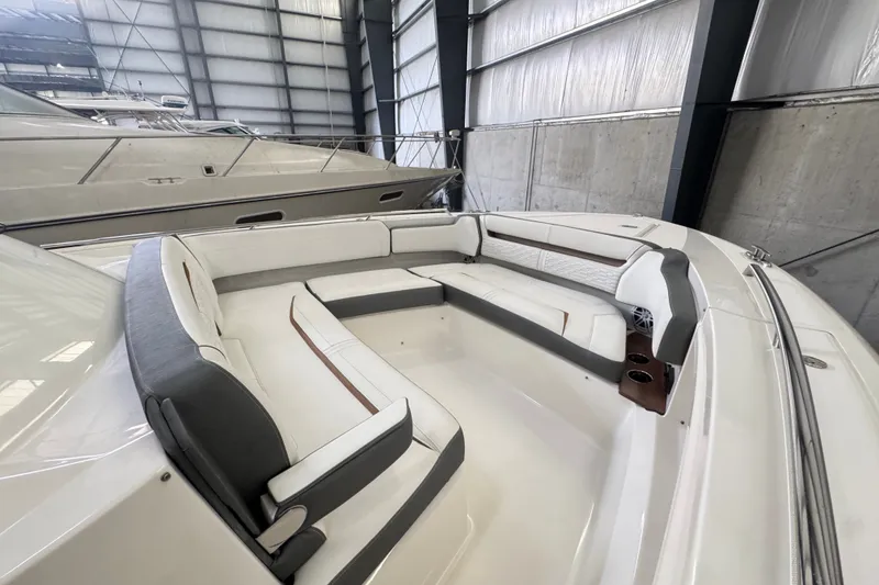 Slide: The Image of 2021 Tiara Sport 38 LS boat interior with luxurious seating in a spacious dock. - 14