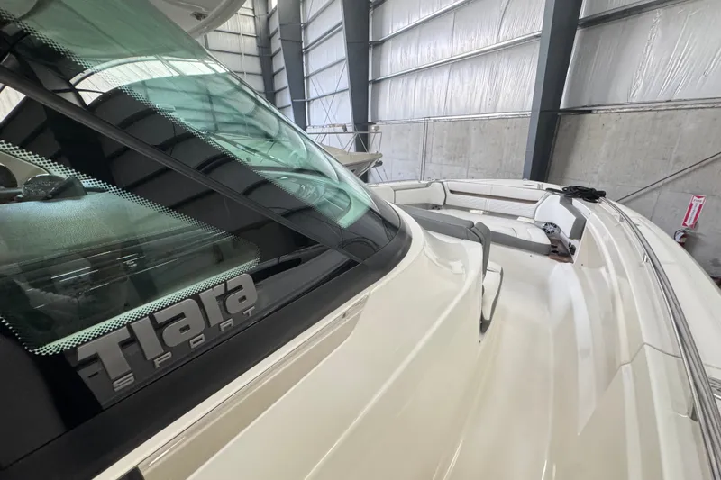 Slide: The Image of 2021 Tiara Sport 38 LS boat in a storage facility, showcasing sleek design and spacious seating. - 11