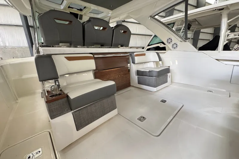 Slide: The Image of 2021 Tiara Sport 38 LS boat interior with modern seating and sleek design. - 6