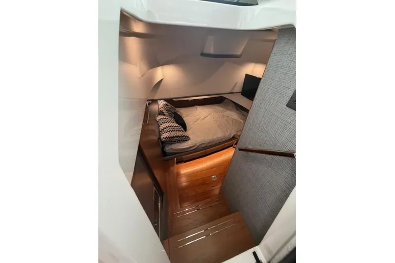 Slide: The Image of 2021 Tiara Sport 38 LS cabin interior with cozy bed and modern lighting. - 23